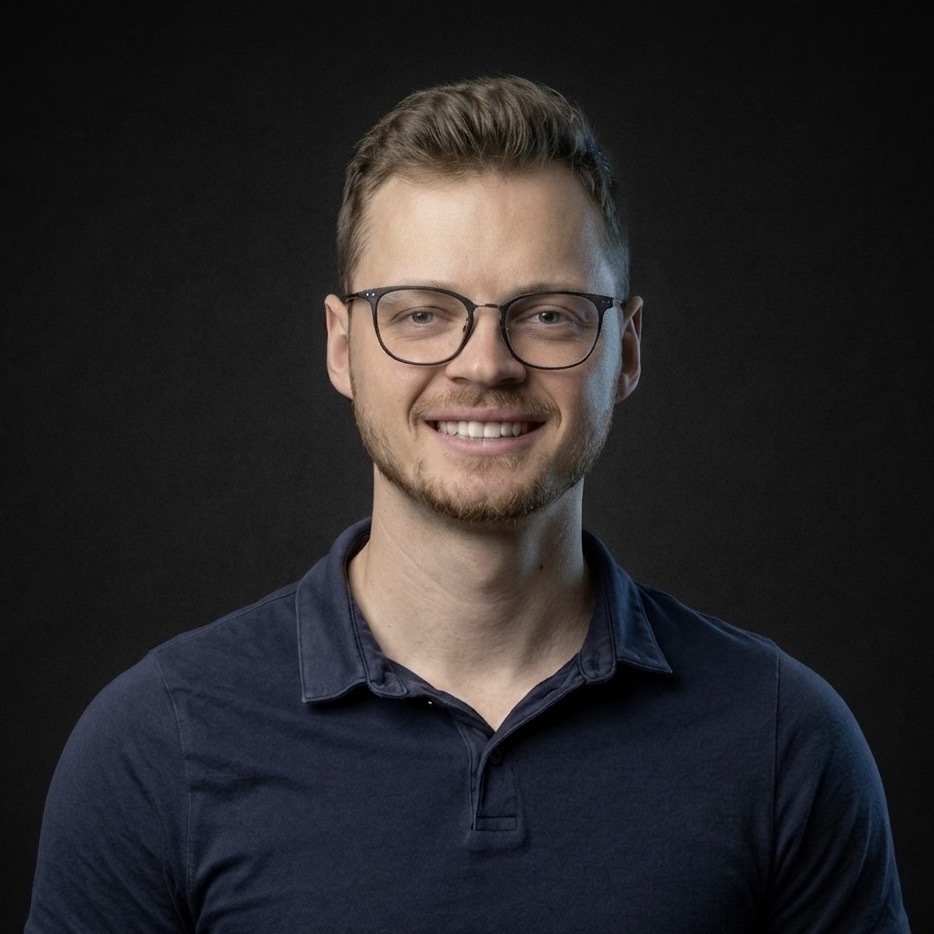 Wesley smiling in a studio portrait.